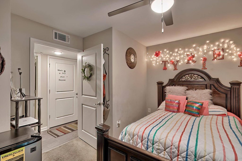 a bedroom decorated for christmas with a bed and christmas lights