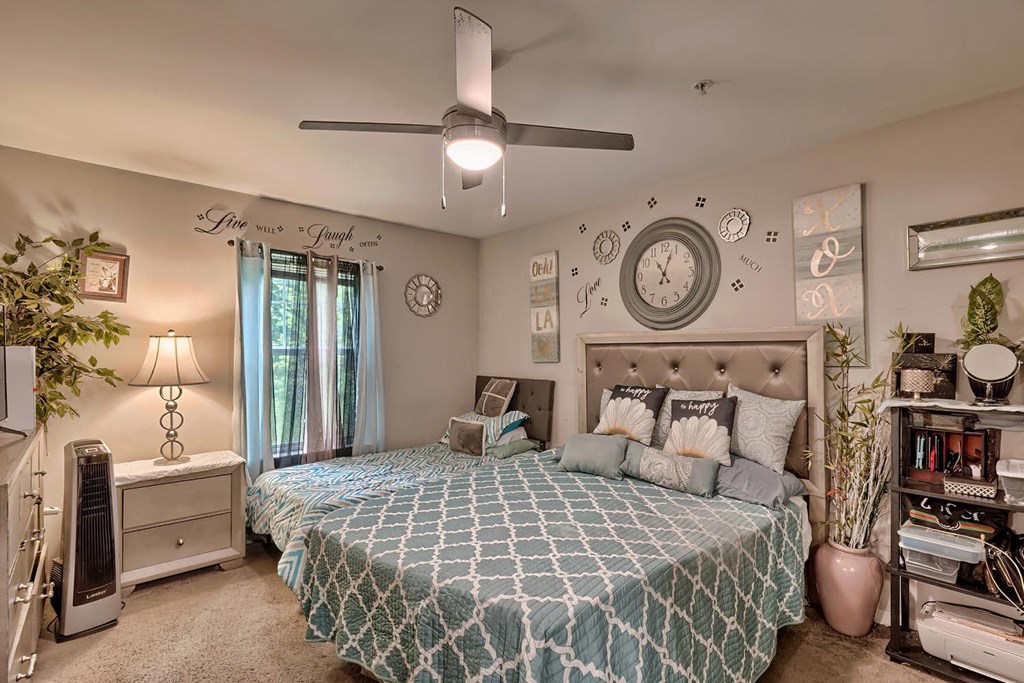 a bedroom with a large bed and a clock on the wall