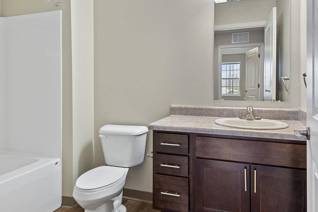 a bathroom with a toilet sink and a mirror