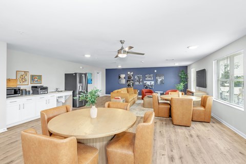 A dining room with a round table and chairs.