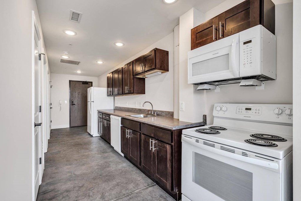 a kitchen with white appliances and wooden cabinets