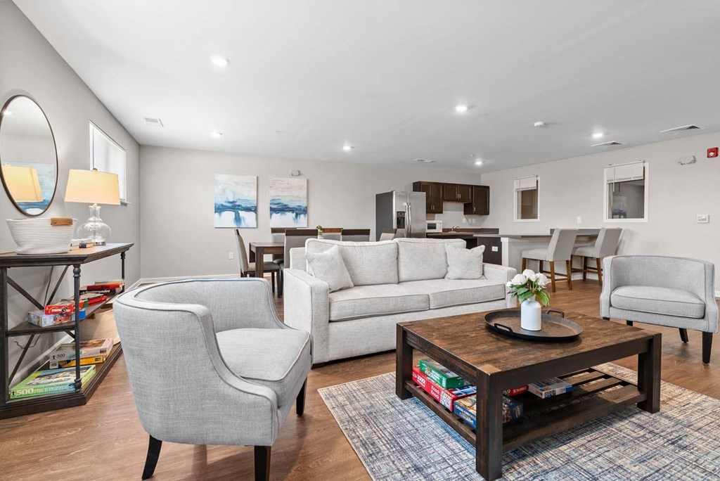 a living room with white couches and chairs