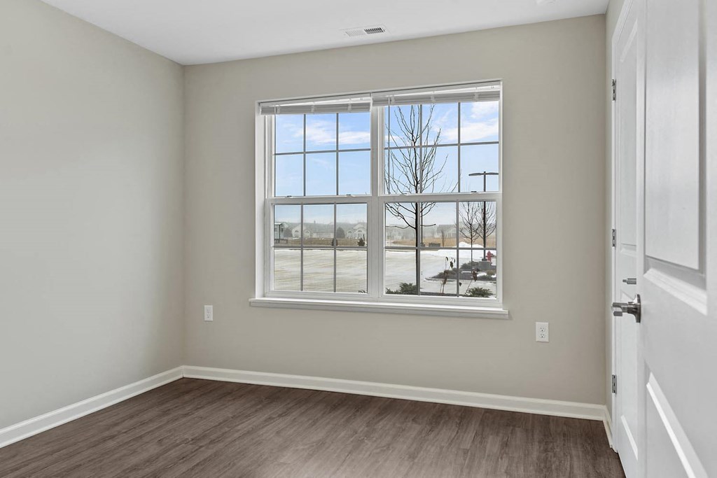 a living room with a large window and a door
