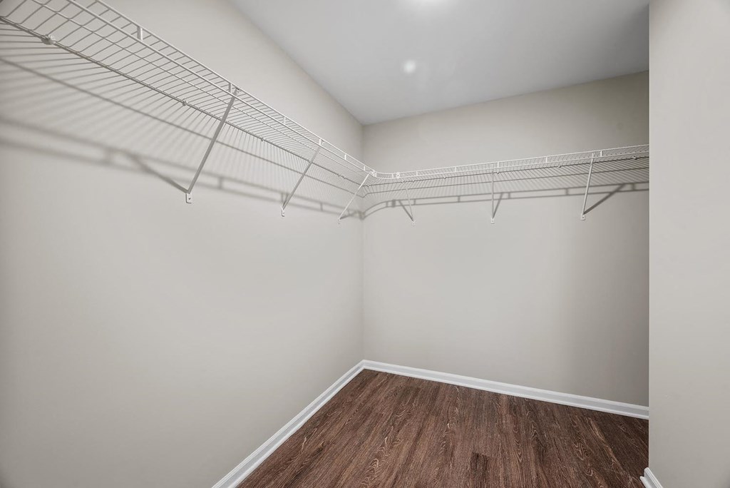 Empty room with white walls and wooden floor.