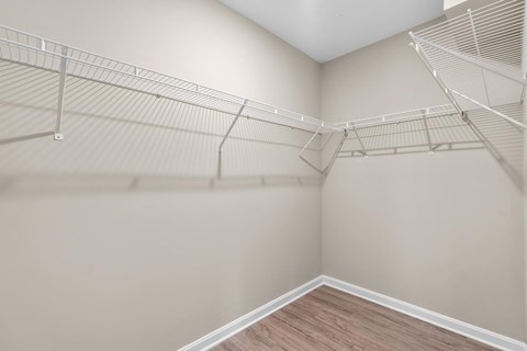 Empty room with white walls and wooden floor.