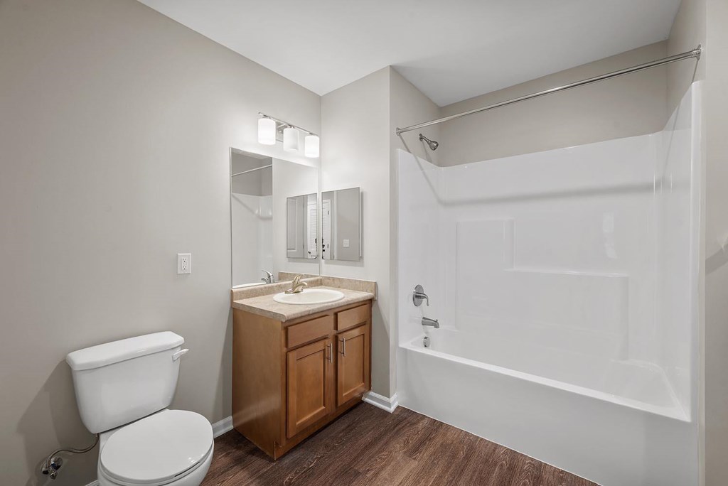 A white toilet sits next to a sink in a small bathroom.