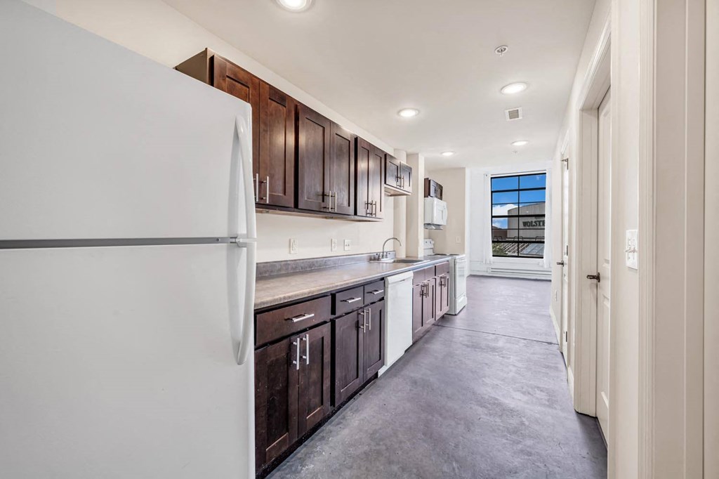 a kitchen with white appliances and wooden cabinets