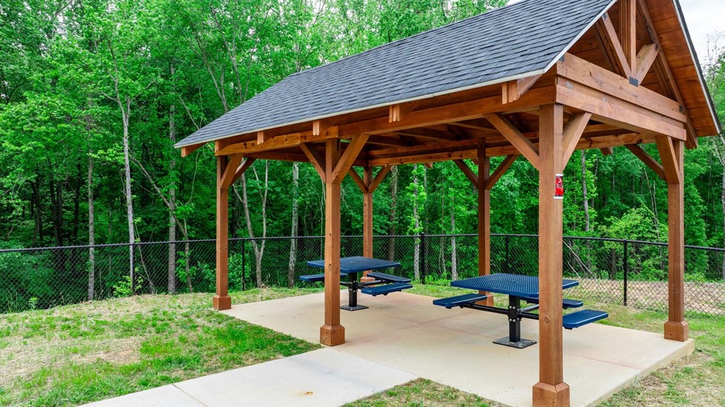 a picnic area with benches and a pavilion