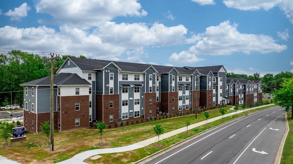 an aerial view of an apartment building on a city street