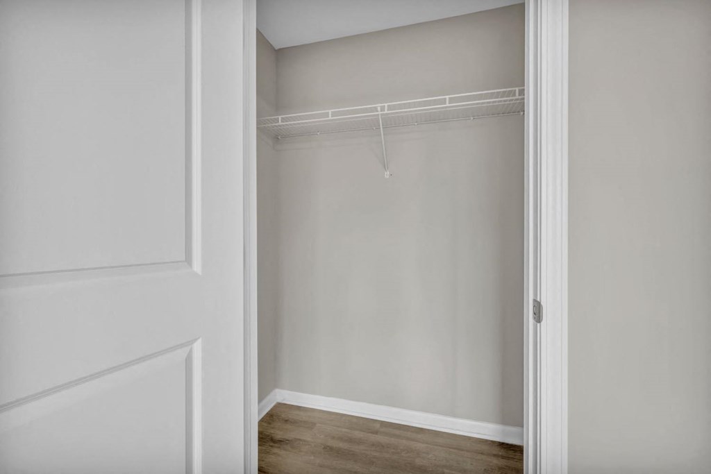 the closet in a bedroom with white walls and a white