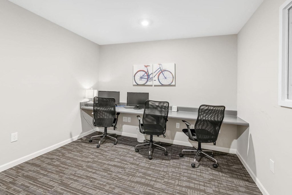 a room with three desks and three chairs