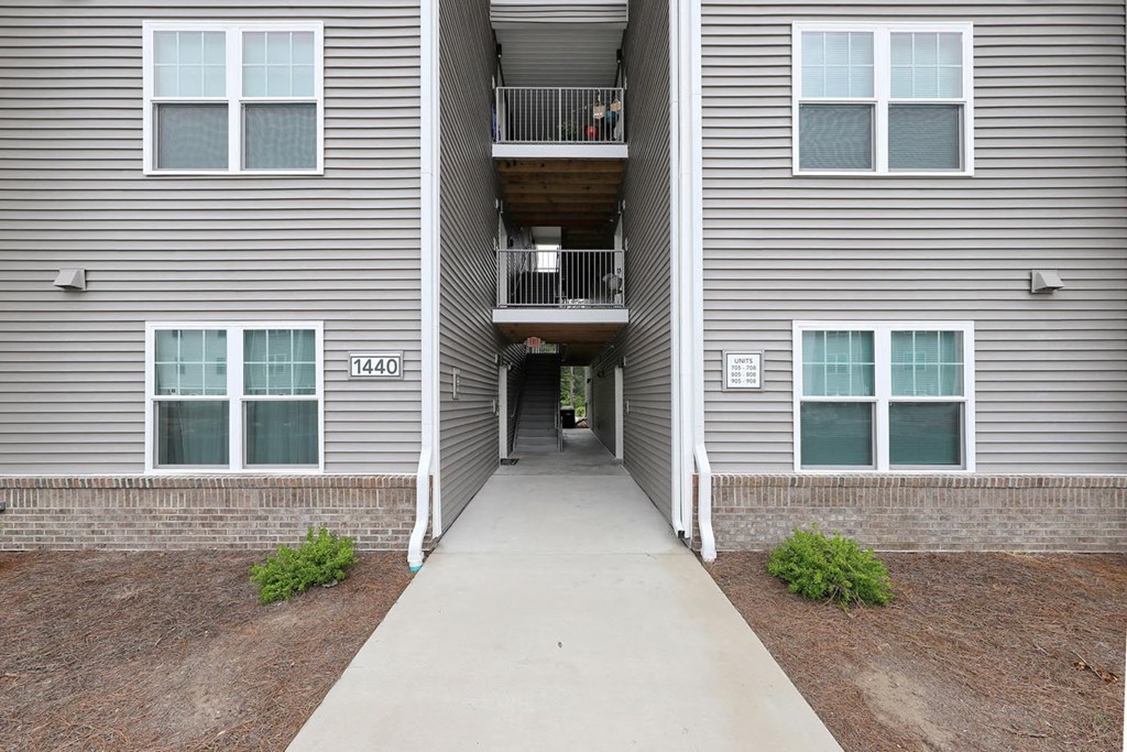 a walkway leading to an apartment building