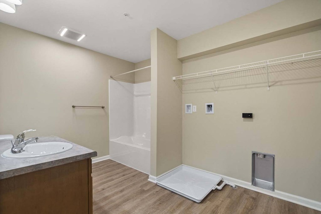 a bathroom with a shower and a sink and a mirror