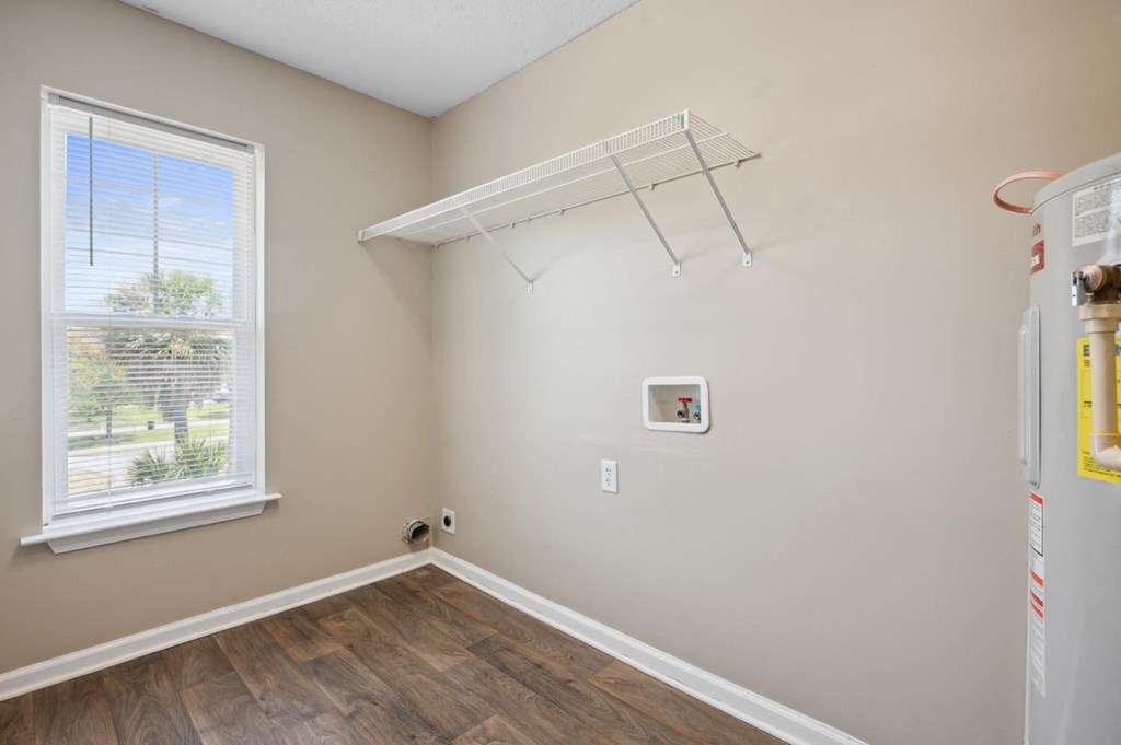 a bedroom with a window and a closet with a rack on the wall