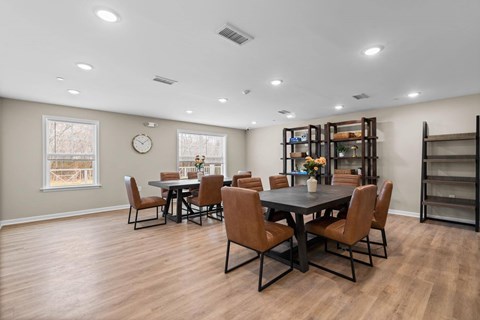 A dining room with a table set for six people.