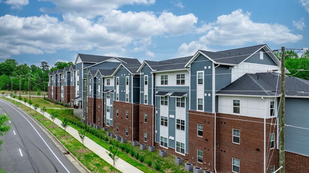 an aerial view of a row of town houses next to a street