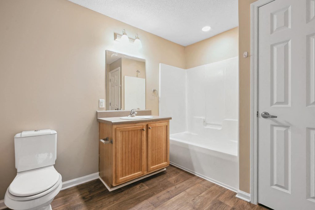 a bathroom with a toilet and a sink and a bath tub
