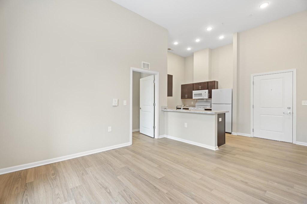 A white reception desk with a white door and a white cabinet with a brown box on top of it.