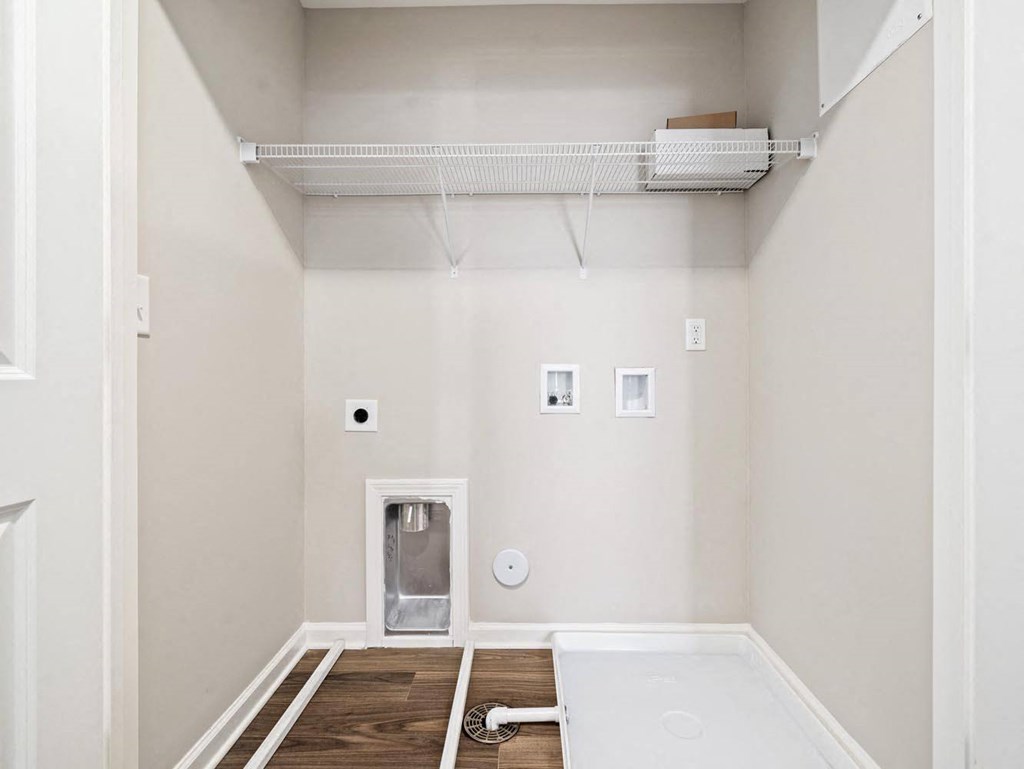 a room with white walls and a white bath tub in it