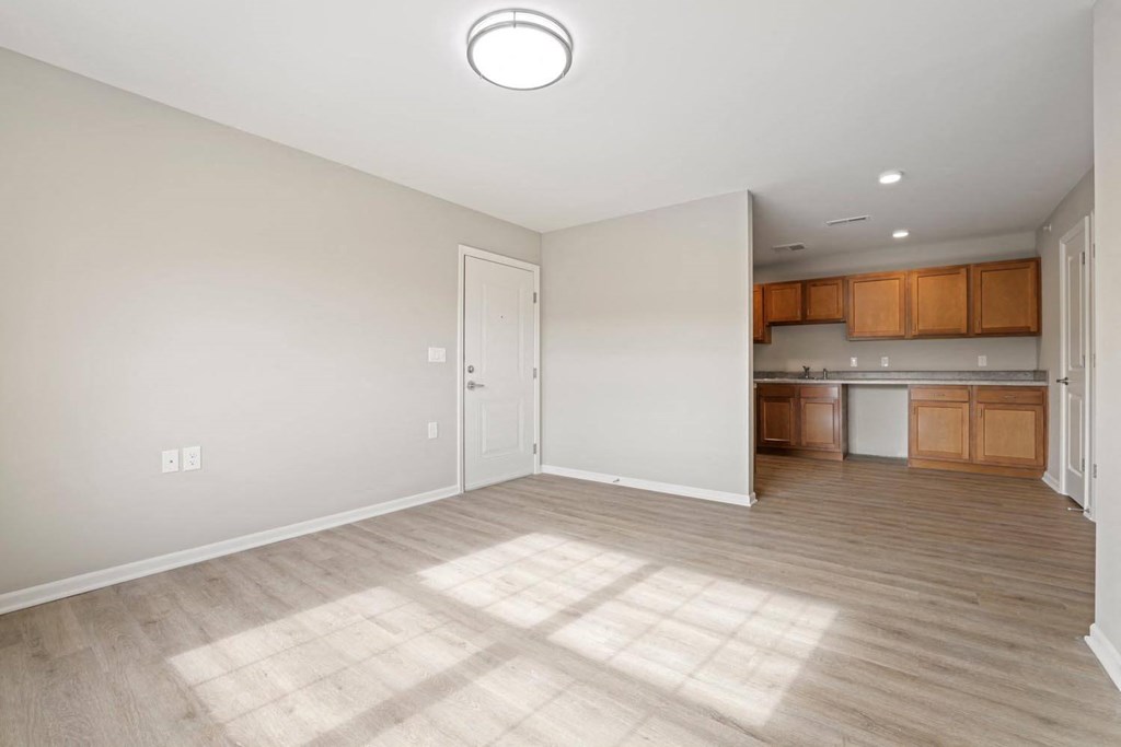 an empty living room and kitchen in a new home
