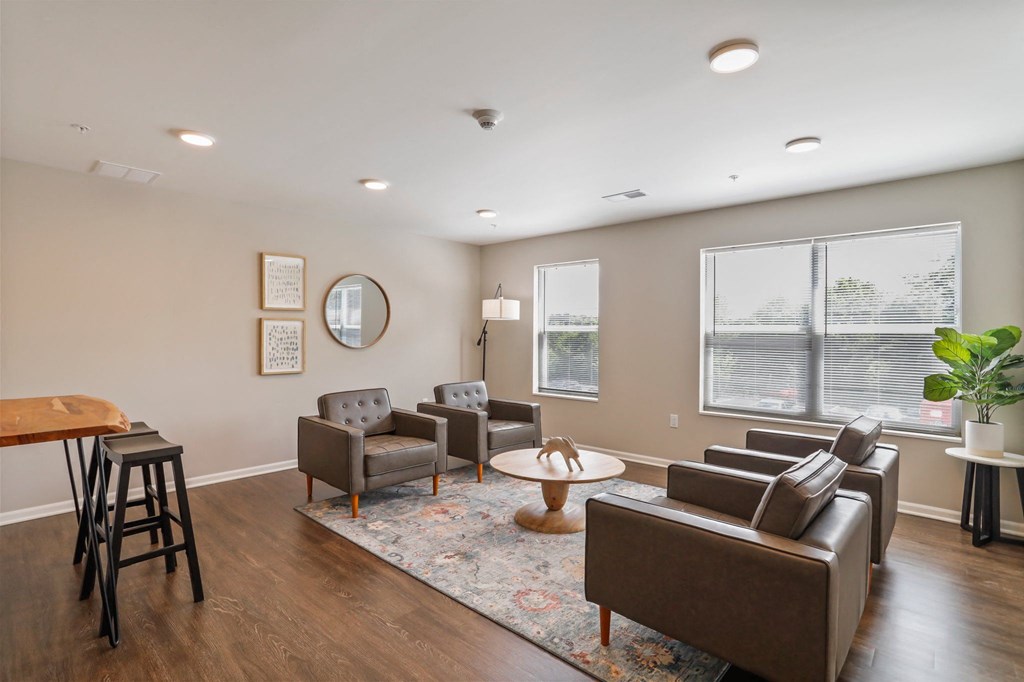 a living room with couches chairs and a coffee table