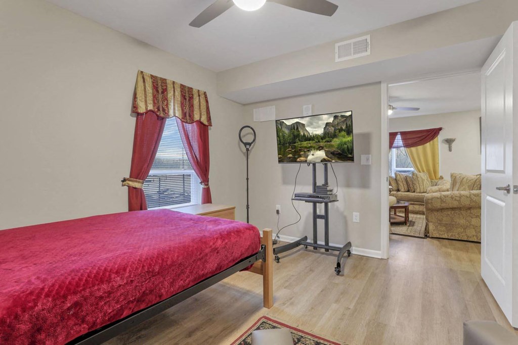 a bedroom with a bed and a mirror in a room