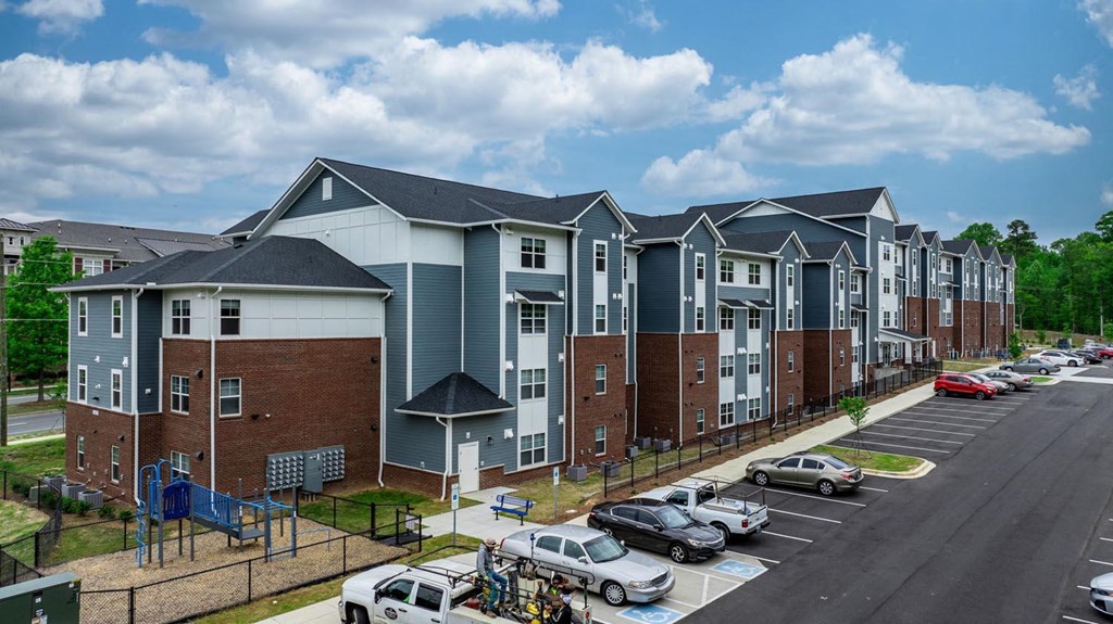an aerial view of an apartment building in a parking lot