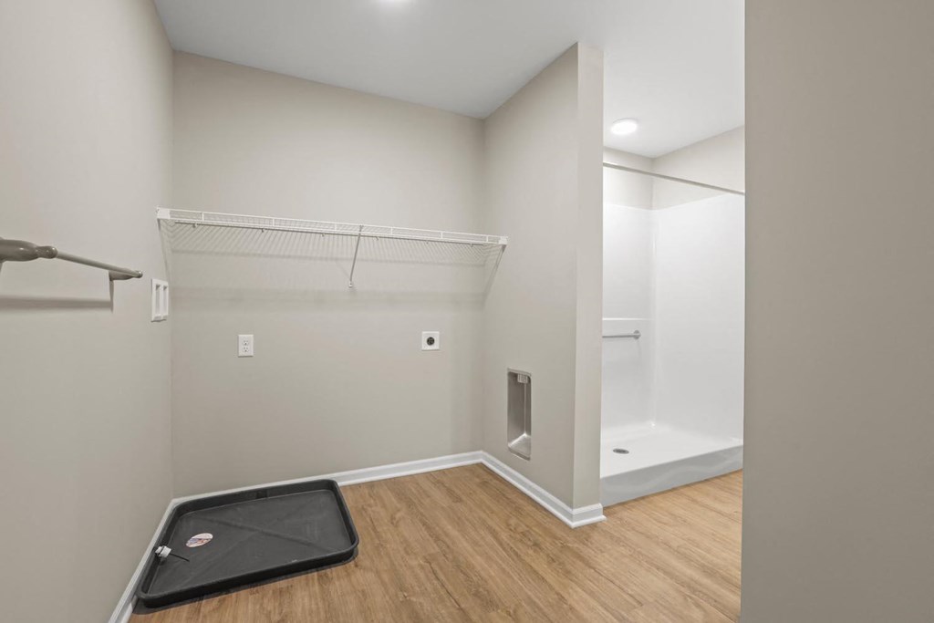 a room with a treadmill and a shower and a closet