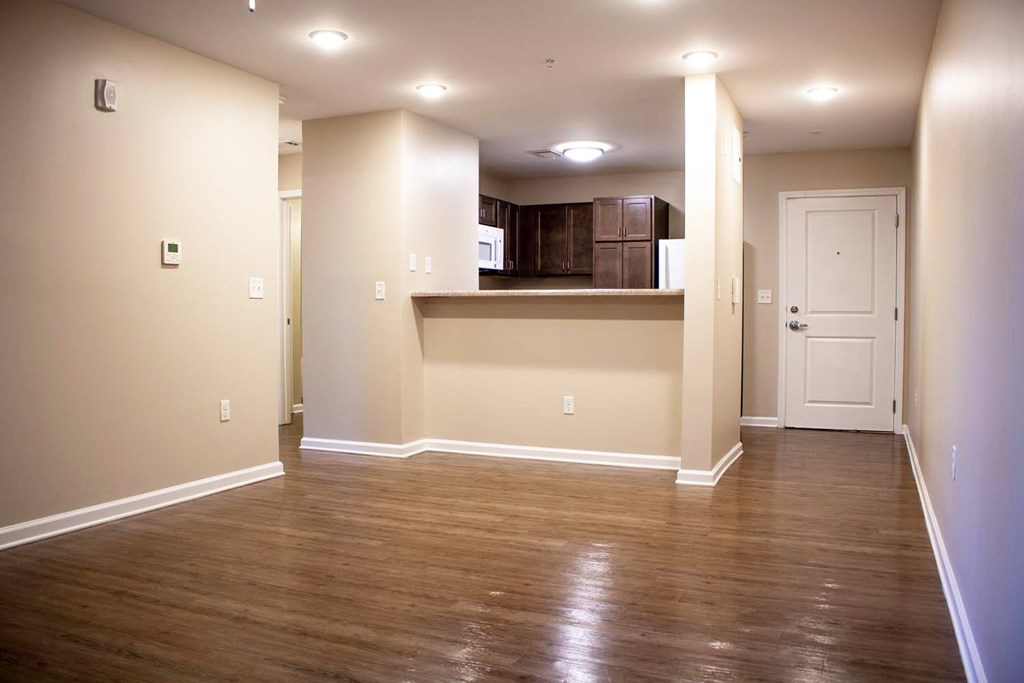 A room with wooden floors and a white door.