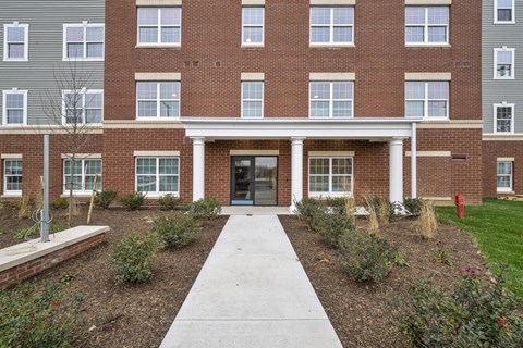 A brick building with a white door and windows.