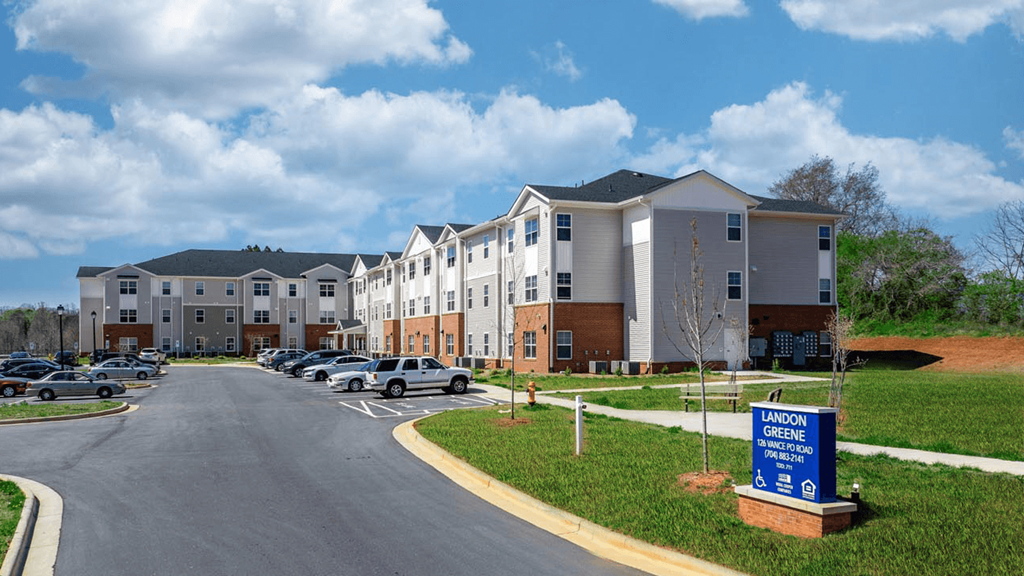 an apartment building with cars parked in front of it
