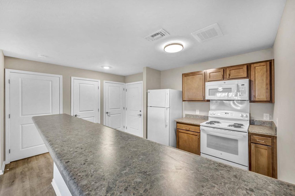 a kitchen with white appliances and a counter top