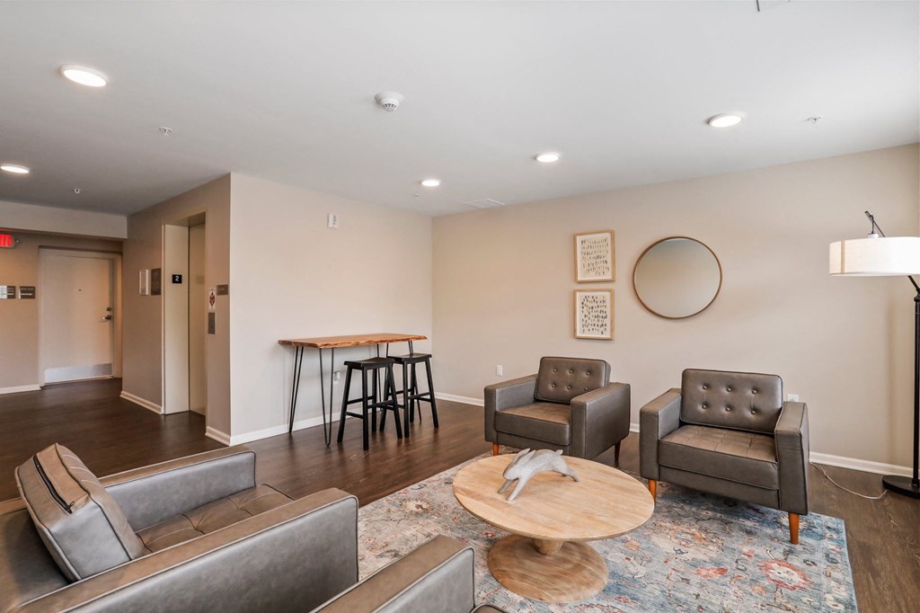 a living room with a couch chairs and a coffee table