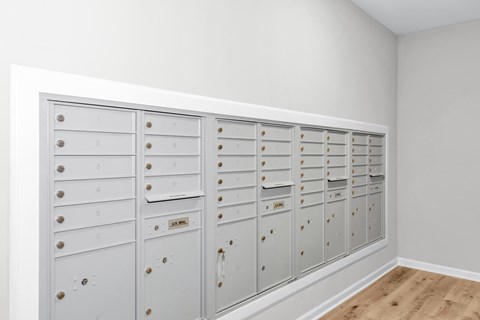 A row of white mailboxes with numbers on them.