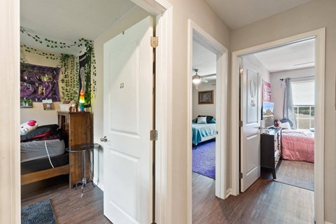 a view of a bedroom and a living room with a door open