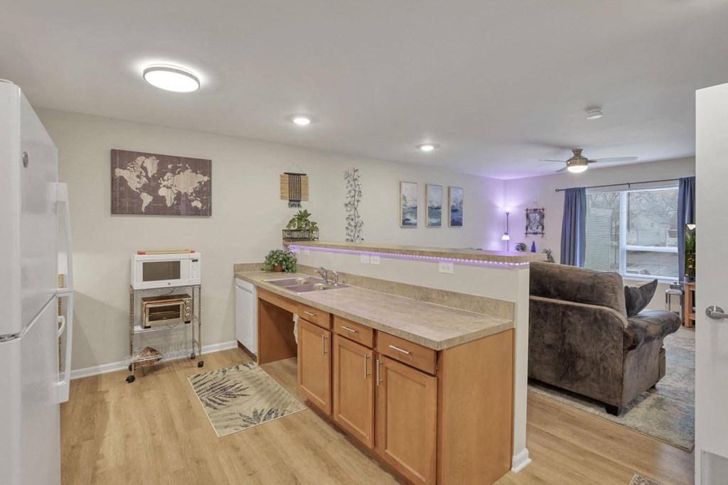 a kitchen with an island and a living room with a couch