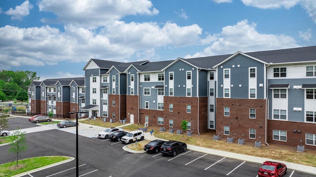 an illustration of a building with cars parked in a parking lot