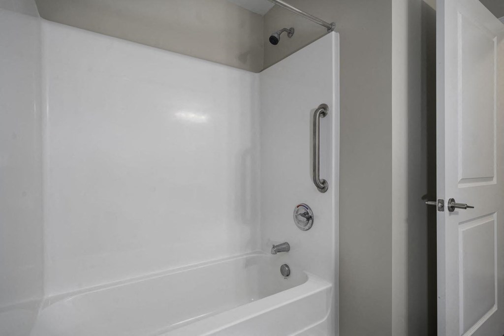a white bathroom with a shower and a tub
