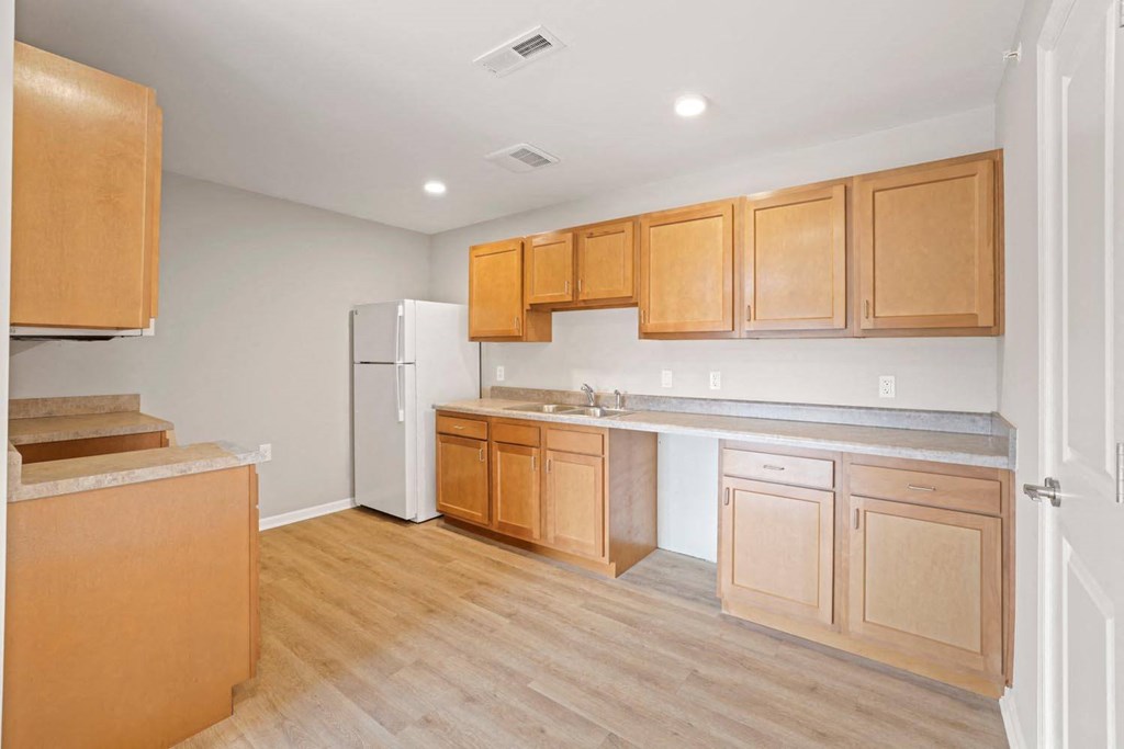 a kitchen with wooden cabinets and a white refrigerator