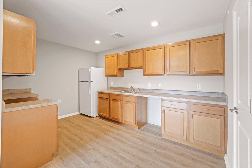a kitchen with wooden cabinets and a white refrigerator