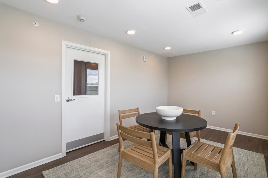 a dining room with a table and chairs