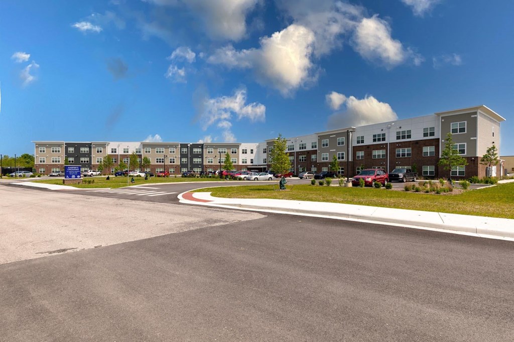 a large building with a parking lot in front of it