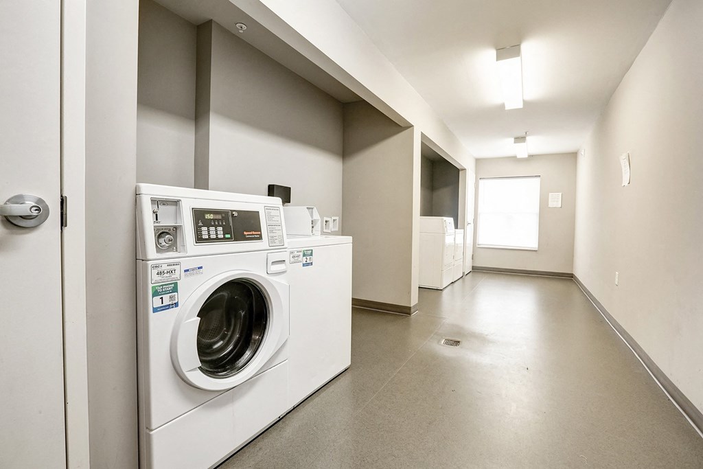 a washing machine and dryer in a laundry room with other appliances