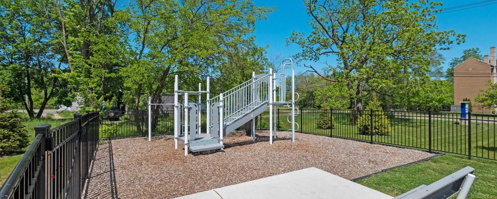 a playground with a slide and monkey bars at the preserve at great pond apartments in windsor