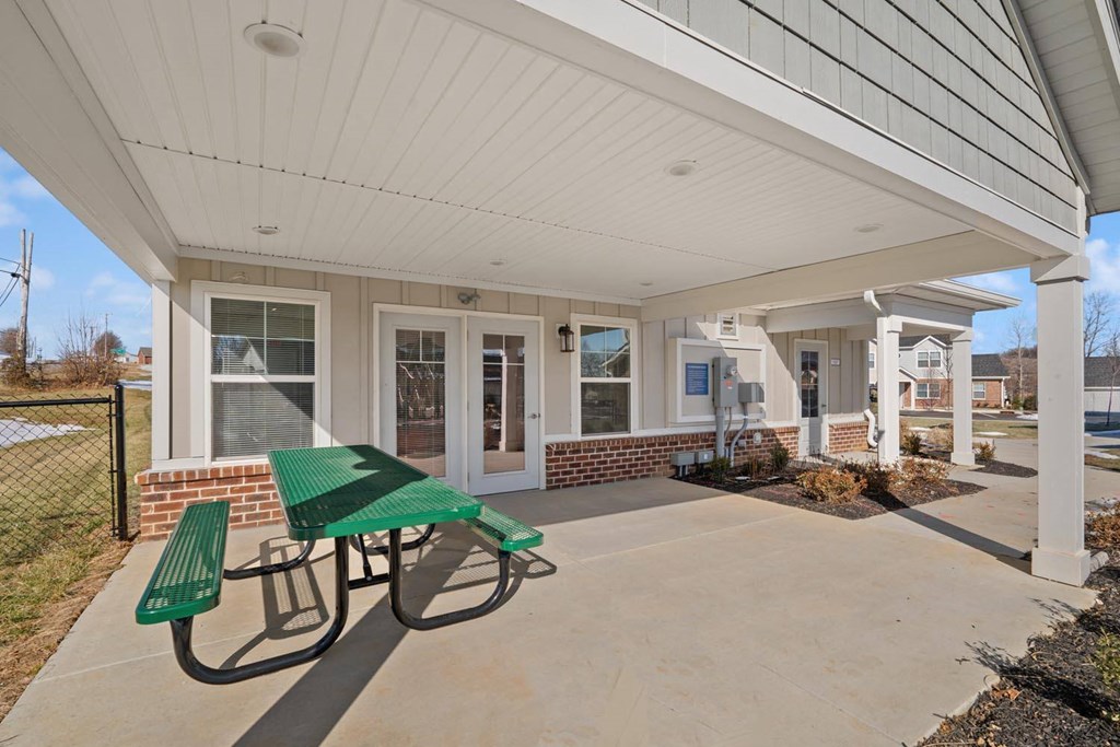 A covered outdoor seating area with a picnic table.