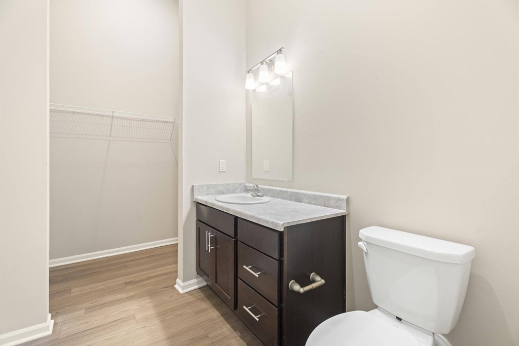A white toilet sits next to a sink in a bathroom.