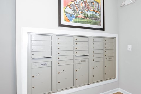 A row of mailboxes are lined up on a wall.