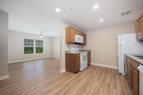 A kitchen with wooden cabinets and a white refrigerator.