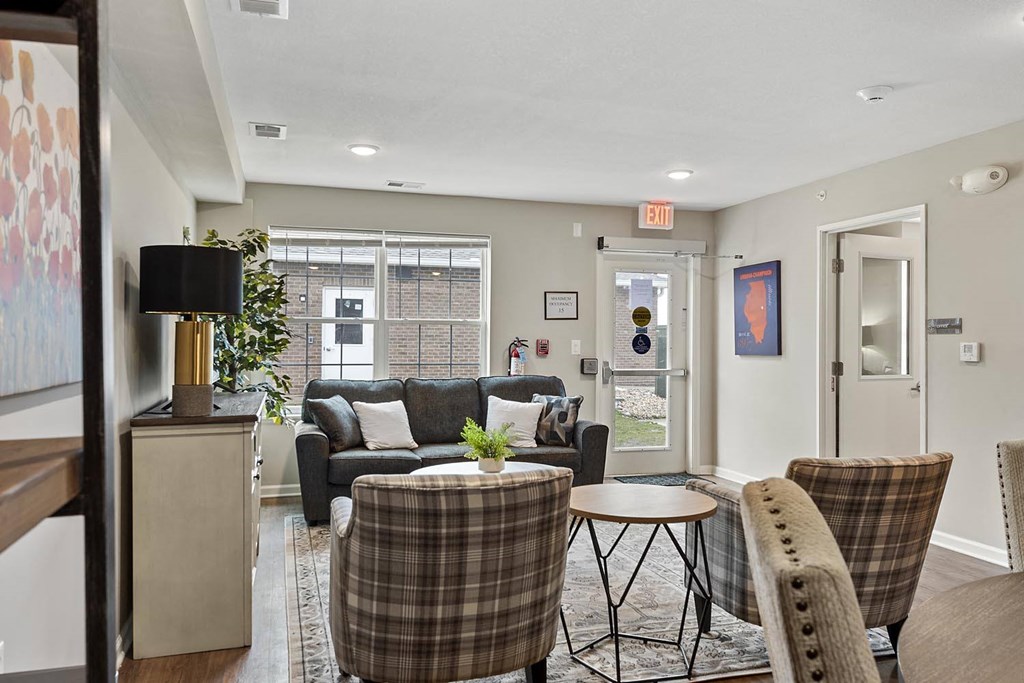 a living room with a couch and chairs and a table