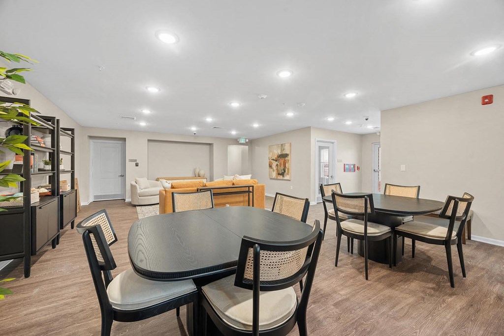 A modern dining room with a round table and chairs.